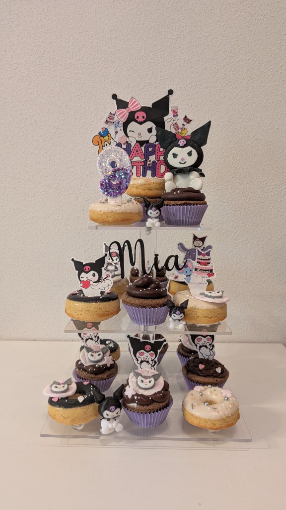 Candy bar temática Kuromi con cupcakes y donuts en soporte de tres pisos